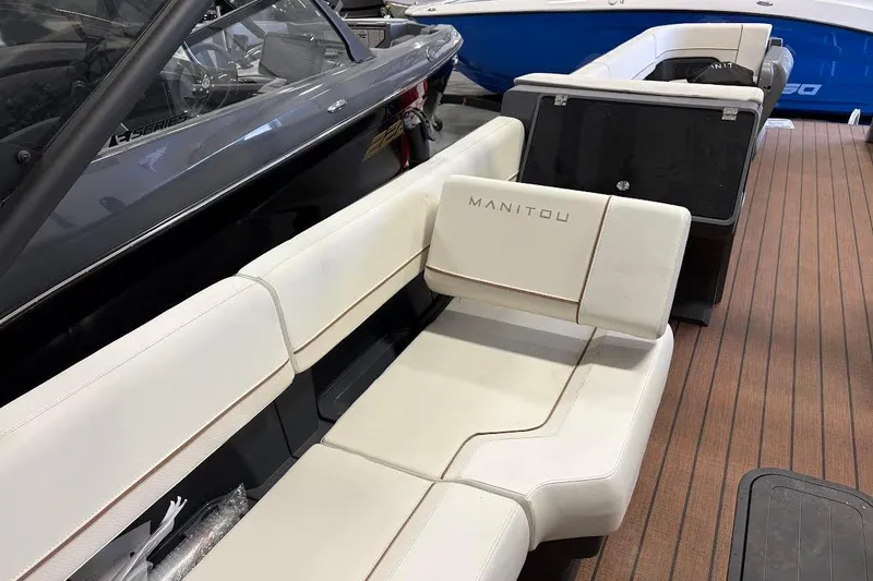 Slide: The Image of 2023 Manitou EXPLORE 26 SHP 575 boat interior with white seating and wood flooring. - 4