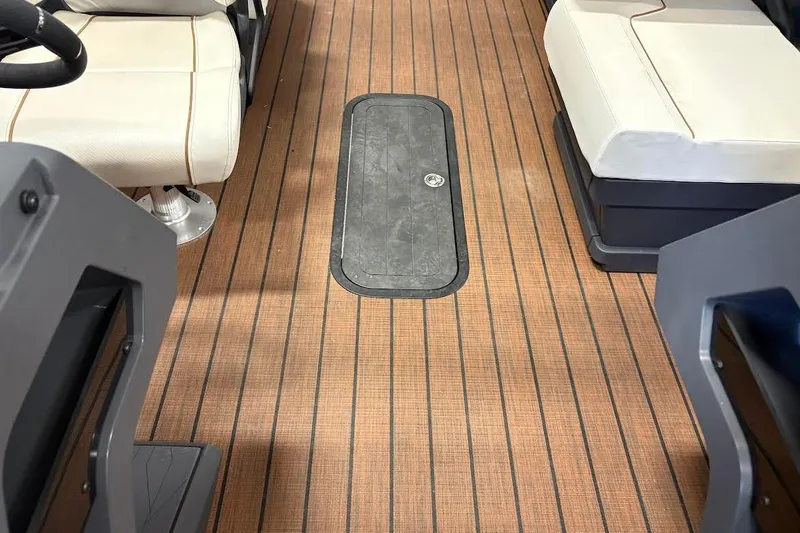 Slide: The Image of 2023 Manitou EXPLORE 26 SHP 575 interior with wood-patterned flooring and cushioned seating. - 7