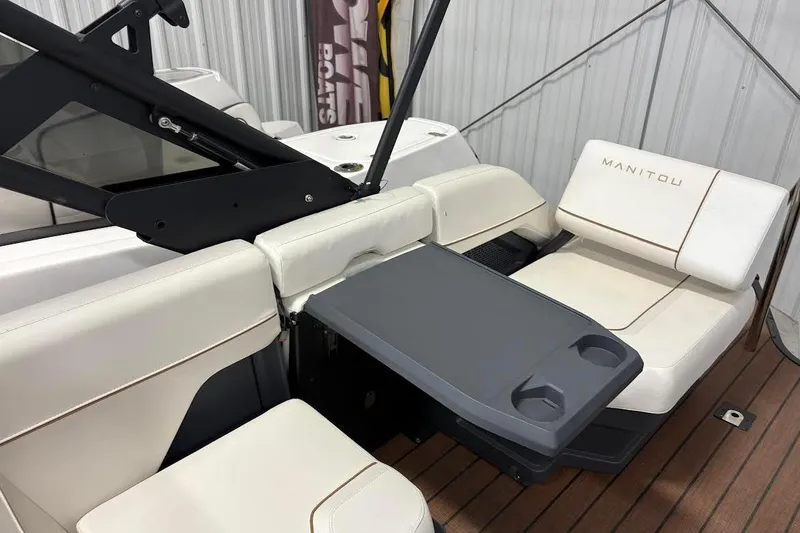 Slide: The Image of 2023 Manitou EXPLORE 26 SHP 575 boat interior with seating and table. - 8
