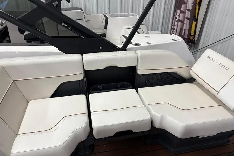 Slide: The Image of 2023 Manitou EXPLORE 26 SHP 575 boat interior with white cushioned seating. - 9