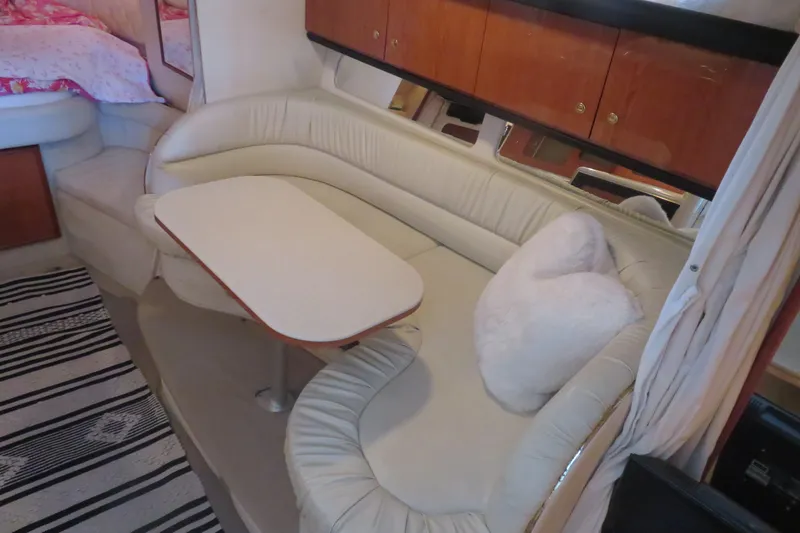 Slide: The Image of Interior of 2001 Sea Ray 340 Sundancer with cozy seating and table. - 10