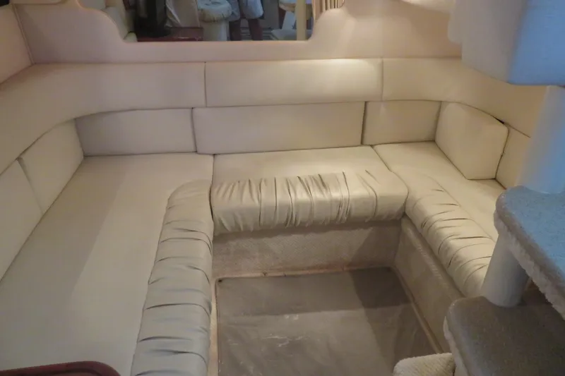 Slide: The Image of Interior seating area of 2001 Sea Ray 340 Sundancer yacht, featuring beige upholstery. - 11