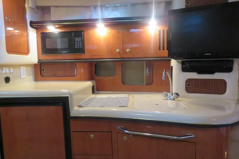 Slide: The Image of Interior of 2001 Sea Ray 340 Sundancer yacht with kitchenette and TV. - 12