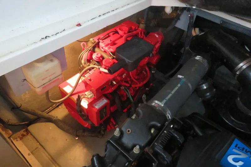 Slide: The Image of Engine compartment of a 2001 Sea Ray 340 Sundancer boat, featuring a red engine. - 15