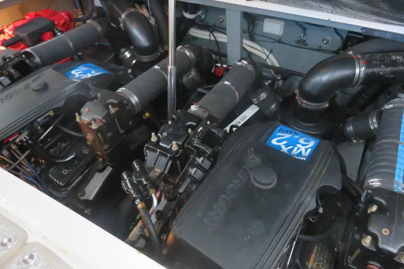 Slide: The Image of Engine compartment of a 2001 Sea Ray 340 Sundancer boat, featuring MerCruiser engines. - 16