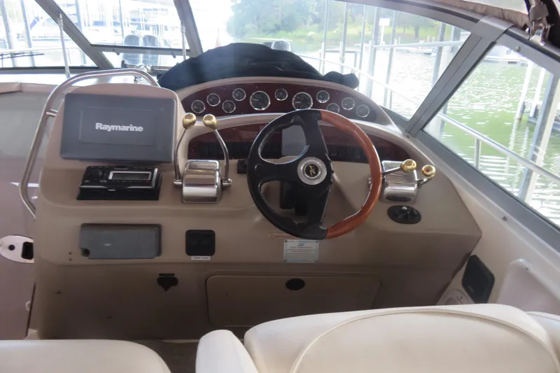 Slide: The Image of Cockpit of 2001 Sea Ray 340 Sundancer with steering wheel and Raymarine navigation system. - 6