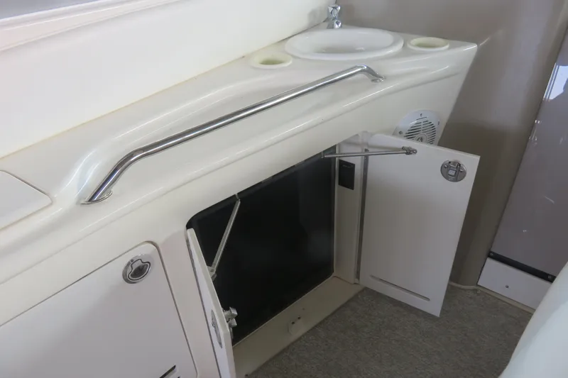 Slide: The Image of 2001 Sea Ray 340 Sundancer interior with sink and open storage cabinet. - 7
