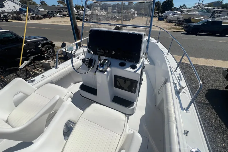 Slide: The Image of 1997 Boston Whaler Outrage 20 boat interior with steering console and seating. - 6