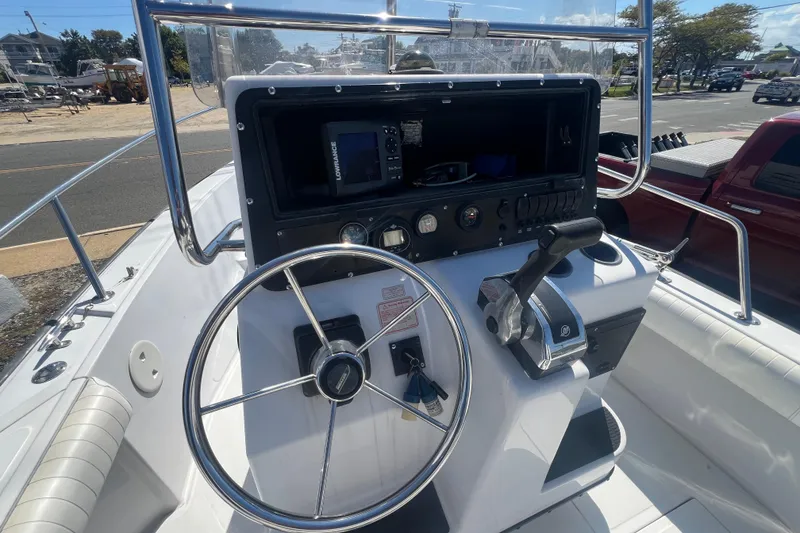 Slide: The Image of 1997 Boston Whaler Outrage 20 boat console with steering wheel and controls. - 7
