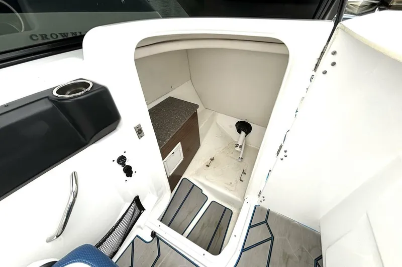 Slide: The Image of 2020 Scarab 255 ID Wake boat interior storage compartment with cup holder and handle. - 32
