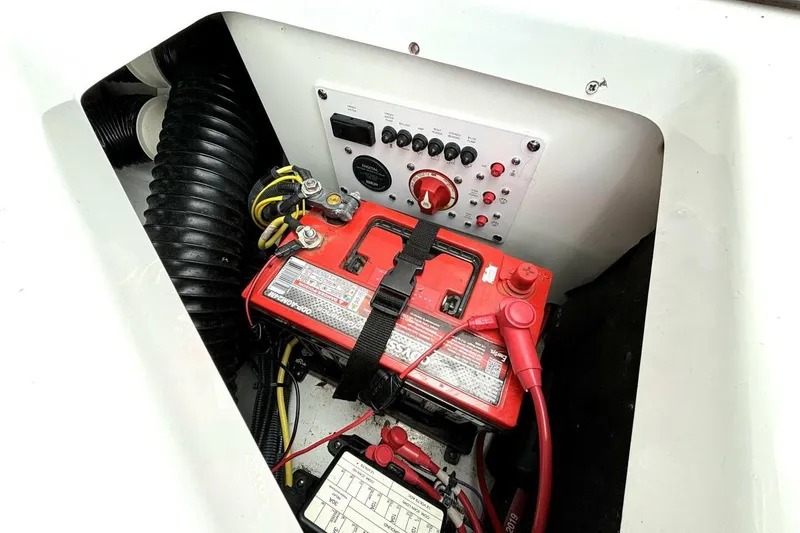 Slide: The Image of 2020 Scarab 255 ID Wake boat battery compartment with control panel and wiring. - 45