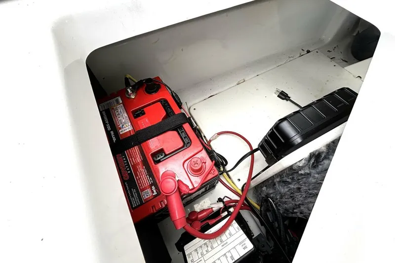 Slide: The Image of Battery compartment of 2020 Scarab 255 ID Wake boat with red Odyssey battery. - 44