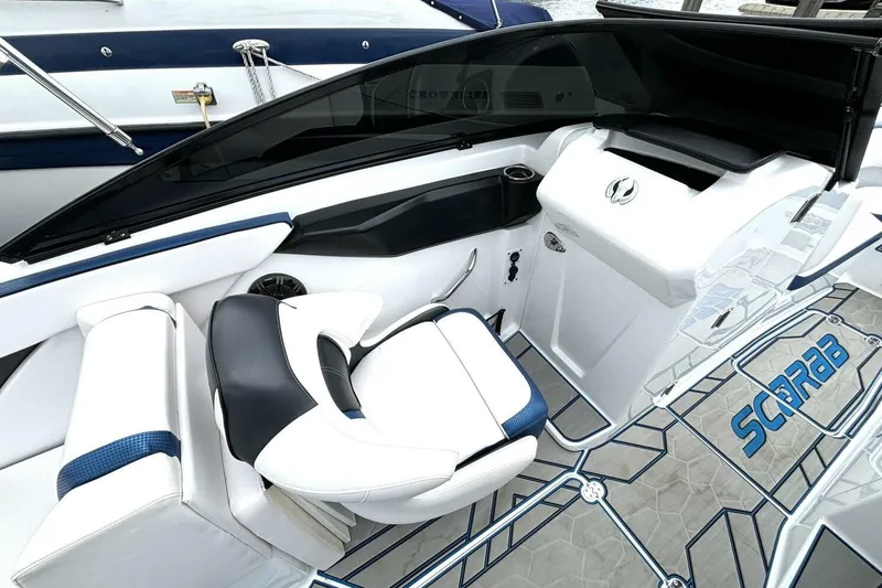 Slide: The Image of 2020 Scarab 255 ID Wake boat interior with sleek white and blue seating. - 18