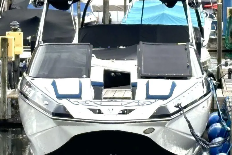 Slide: The Image of 2020 Scarab 255 ID Wake boat docked at marina with protective covers. - 7