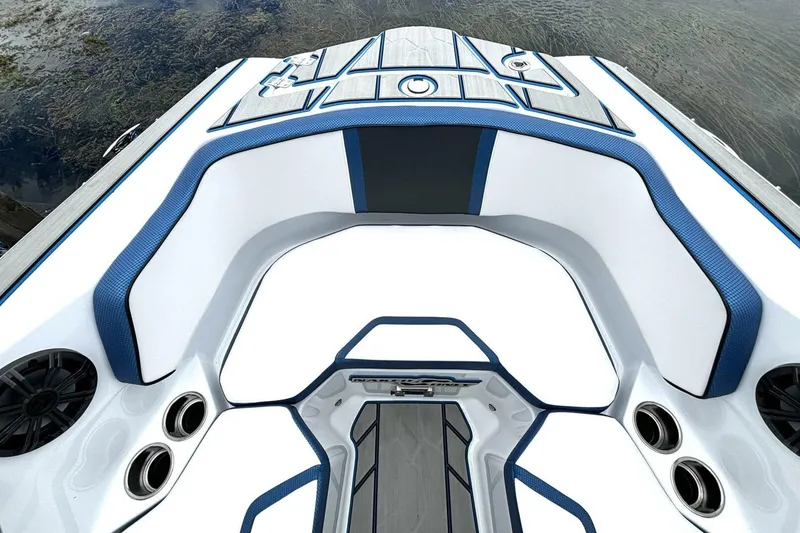 Slide: The Image of 2020 Scarab 255 ID Wake boat interior with blue and white seating, speakers, and cup holders. - 29