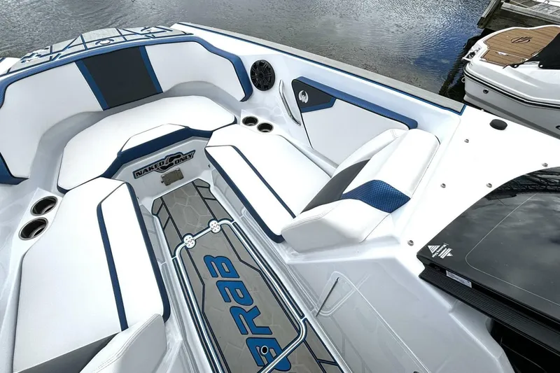 Slide: The Image of 2020 Scarab 255 ID Wake boat interior with white and blue seating, on calm water. - 28