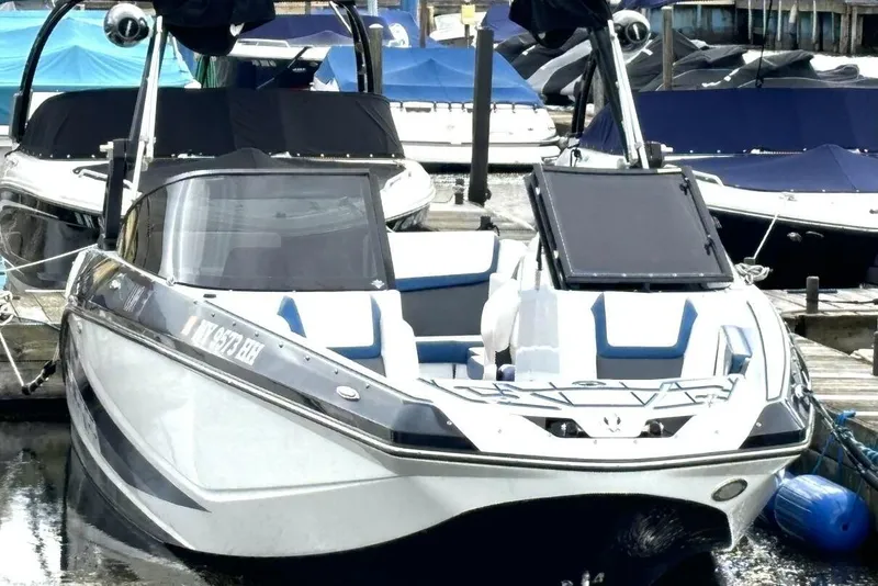 Slide: The Image of 2020 Scarab 255 ID Wake boat docked, featuring sleek design and modern amenities. - 6