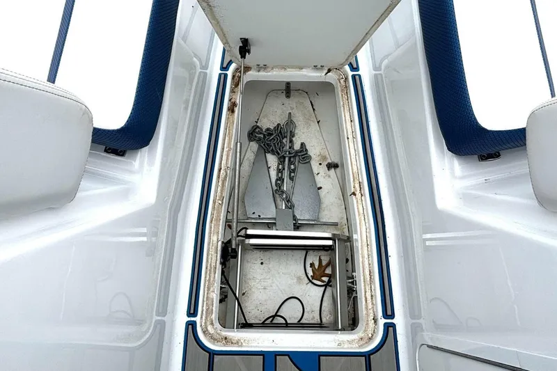 Slide: The Image of Open storage compartment on 2020 Scarab 255 ID Wake boat, showing anchor and chain. - 33