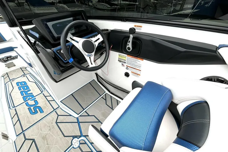 Slide: The Image of 2020 Scarab 255 ID Wake boat interior with steering wheel and blue seating. - 21