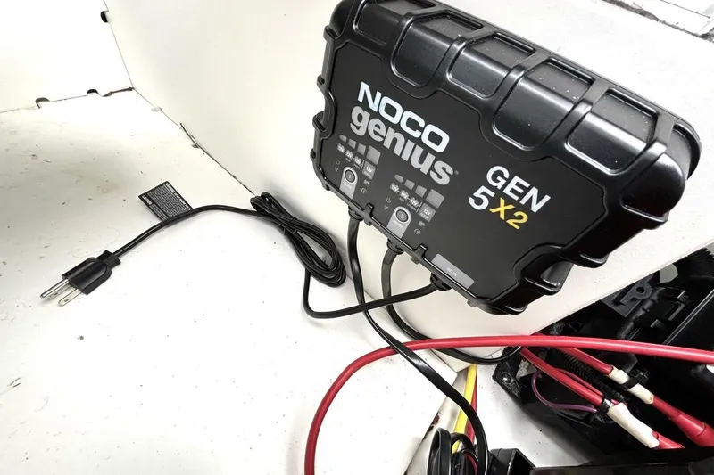 Slide: The Image of NOCO Genius GEN5X2 charger in 2020 Scarab 255 ID Wake boat interior. - 46