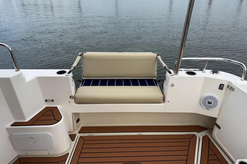 Slide: The Image of 2022 Ranger Tugs R-31 CB boat deck with cushioned seating and wood-style flooring. - 15