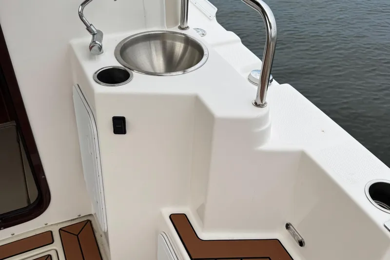 Slide: The Image of Ranger Tugs R-31 CB 2022 boat sink and counter by water. - 16