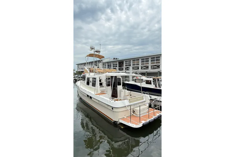 Slide: The Image of 2022 Ranger Tugs R-31 CB boat docked at marina under cloudy sky. - 5