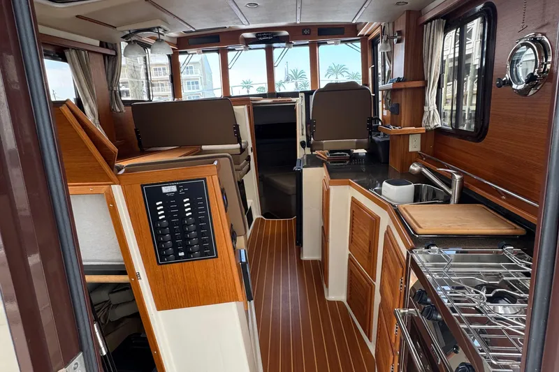 Slide: The Image of Interior of 2022 Ranger Tugs R-31 CB, featuring wood finishes and modern amenities. - 52
