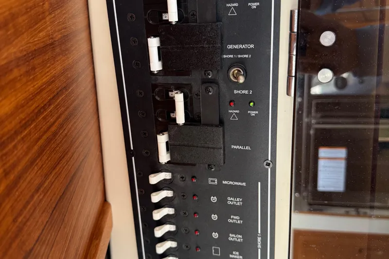 Slide: The Image of Electrical panel of 2022 Ranger Tugs R-31 CB boat, featuring various switches and indicators. - 55