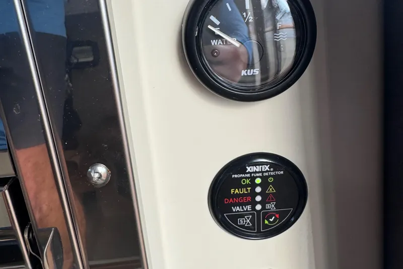 Slide: The Image of 2022 Ranger Tugs R-31 CB water gauge and propane fume detector panel. - 57