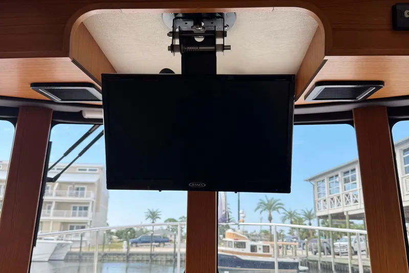 Slide: The Image of Interior of 2022 Ranger Tugs R-31 CB with mounted Jensen TV, marina view. - 61