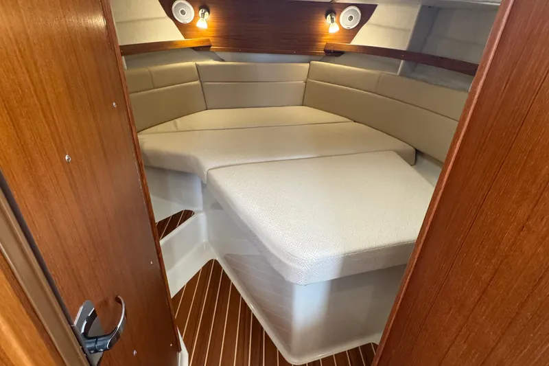 Slide: The Image of 2022 Ranger Tugs R-31 CB cabin interior with cozy seating and warm lighting. - 67