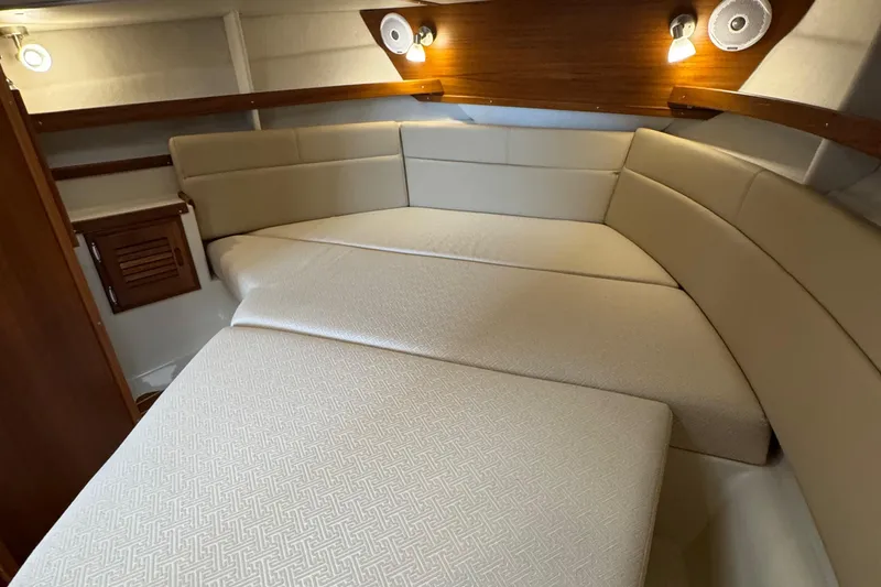 Slide: The Image of 2022 Ranger Tugs R-31 CB cabin interior with beige upholstery and wooden accents. - 68