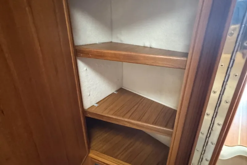 Slide: The Image of Wooden shelving inside a Ranger Tugs R-31 CB, 2022 model, showcasing storage space. - 70