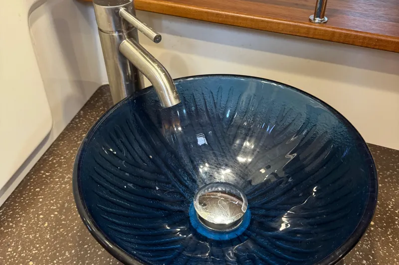 Slide: The Image of Blue glass sink with modern faucet on Ranger Tugs R-31 CB, 2022 model. - 72