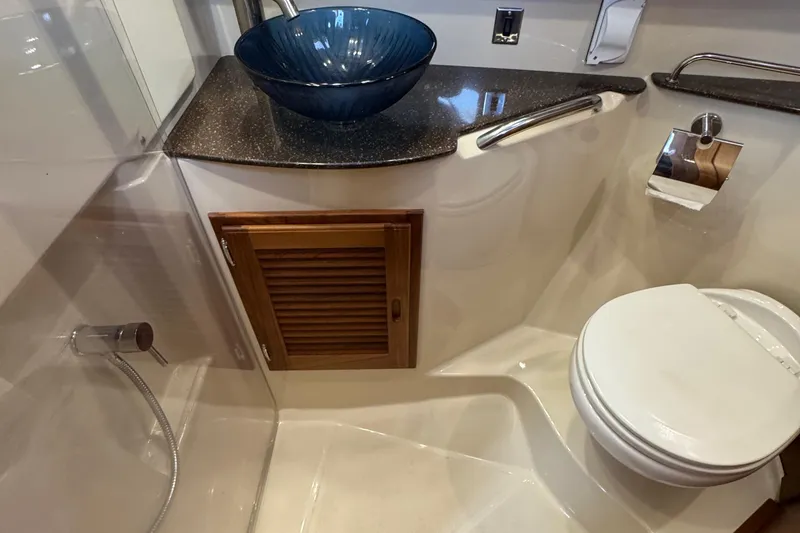 Slide: The Image of 2022 Ranger Tugs R-31 CB bathroom with modern sink, toilet, and wooden cabinet. - 73