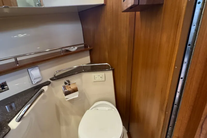 Slide: The Image of 2022 Ranger Tugs R-31 CB bathroom with wooden paneling and modern fixtures. - 74
