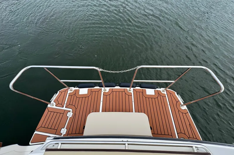 Slide: The Image of 2022 Ranger Tugs R-31 CB swim platform with teak decking and stainless steel rails. - 9
