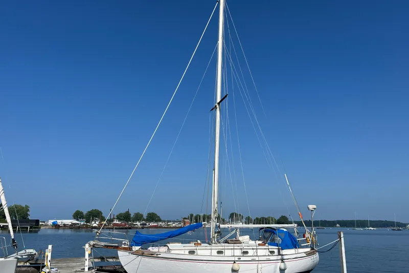 The Image of 1982 Tayana 37 sailboat docked under clear blue sky. - 0