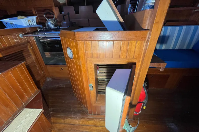 Slide: The Image of Interior of 1982 Tayana 37 sailboat with wooden cabinetry and kitchen area. - 32