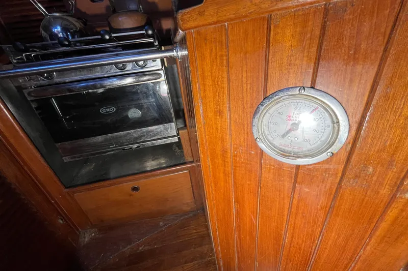 Slide: The Image of Wooden interior of 1982 Tayana 37 yacht with oven and thermometer. - 33