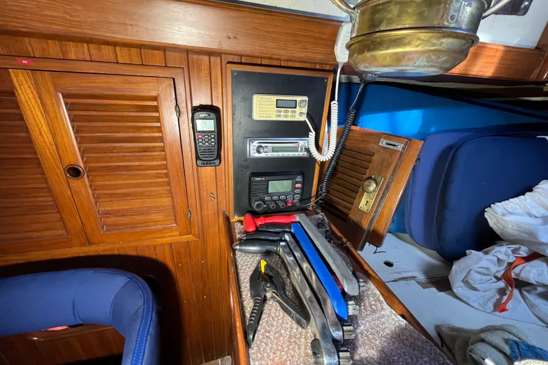 Slide: The Image of Interior of 1982 Tayana 37 sailboat with navigation equipment and wooden cabinetry. - 36