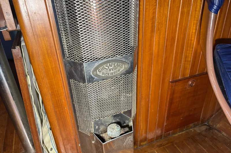 Slide: The Image of Chesapeake by Dickinson heater inside 1982 Tayana 37 sailboat with wooden interior. - 44