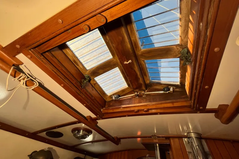 Slide: The Image of Wooden hatch interior of 1982 Tayana 37 sailboat, showcasing craftsmanship and natural light. - 45