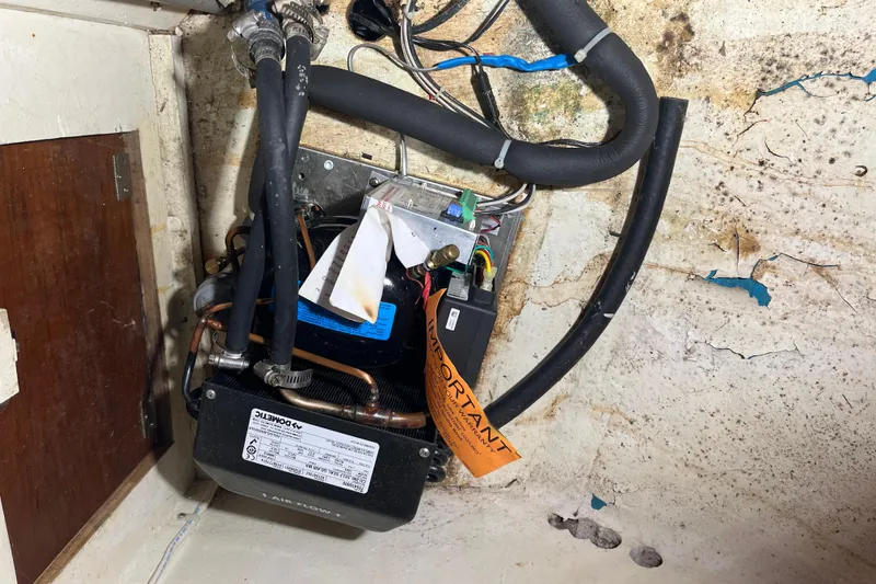 Slide: The Image of Electrical system inside 1982 Tayana 37 sailboat, featuring wires and components. - 51