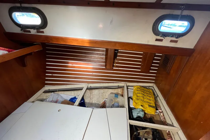Slide: The Image of Interior of 1982 Tayana 37 sailboat with storage compartments and wooden paneling. - 59