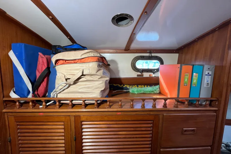 Slide: The Image of Interior storage area of 1982 Tayana 37 sailboat with bags and binders. - 60