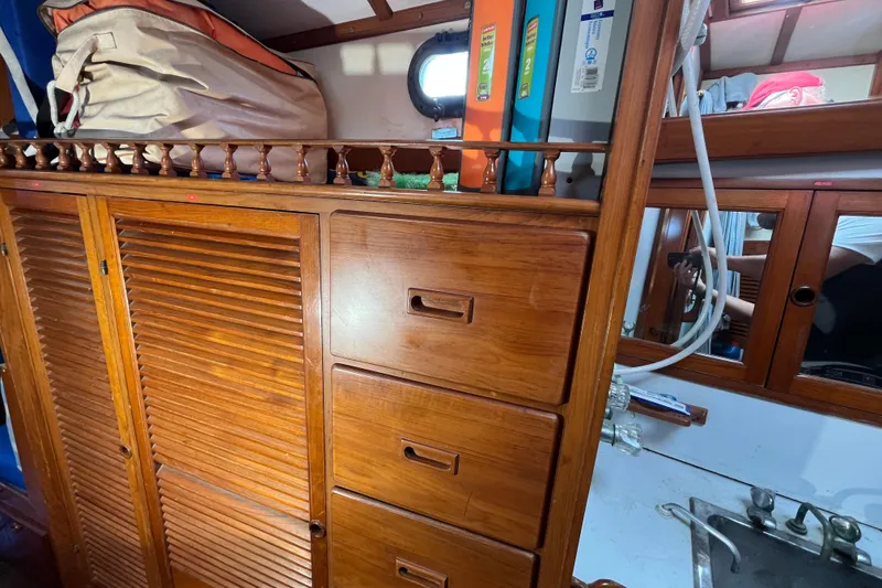 Slide: The Image of Interior of 1982 Tayana 37 sailboat with wooden cabinetry and storage. - 61