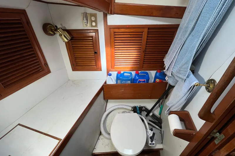 Slide: The Image of 1982 Tayana 37 yacht bathroom with wooden cabinets and marine toilet. - 69