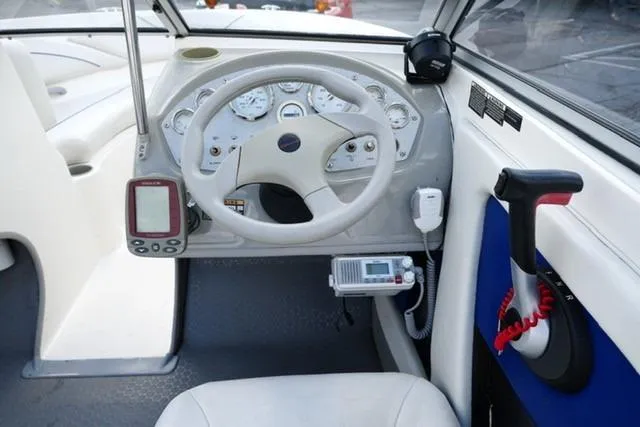 Slide: The Image of 2006 Bayliner 195 Classic boat dashboard with steering wheel and navigation instruments. - 10